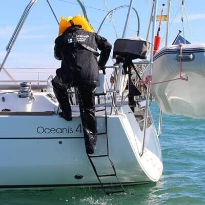 Person using an Emergency Boat Ladder to re-board their sailboat after swimming.