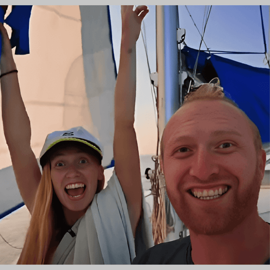 Iain and Brioni on their boat with big smiles