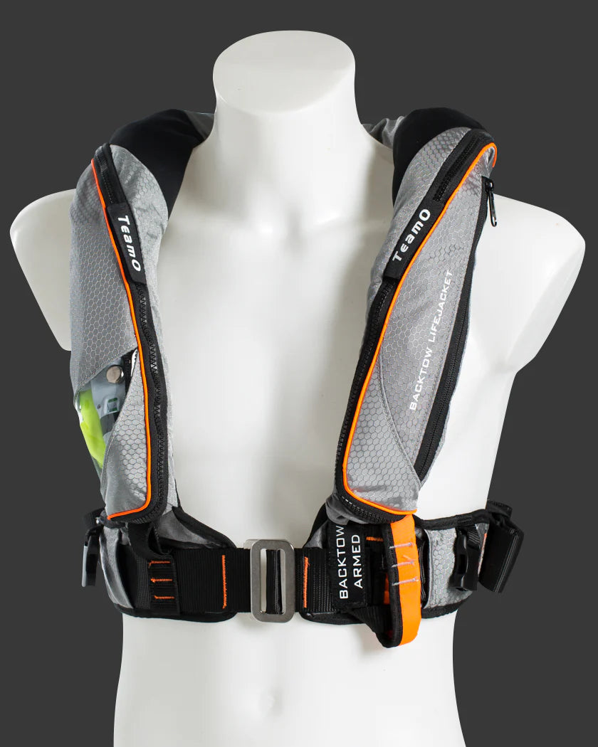 Gray and black TeamO Offshore pro sensor PFD with backtow  harness with orange accents on a mannequin against a dark background