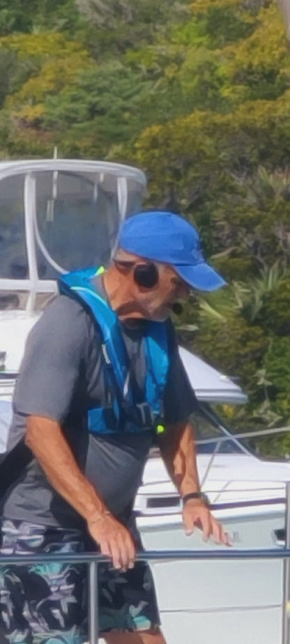 Boater wearing a 2Talk Bluetooth headset while working on deck
