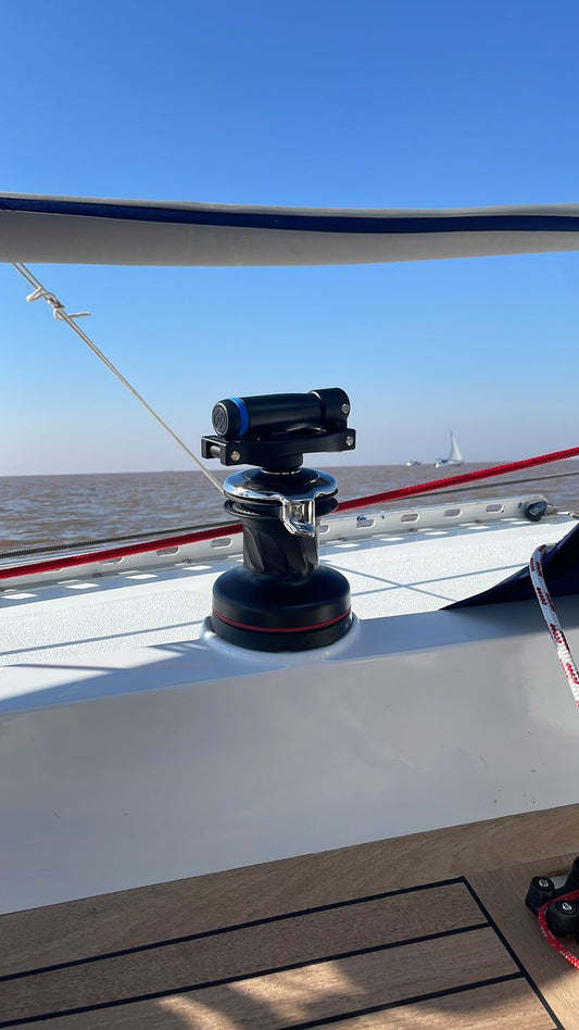 Folding winch handle EasySea shown mounted on a sailboat with blue sky and water in the background.